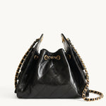 Diamant black quilted leather drawstring bucket bag with antique gold chain straps – front view