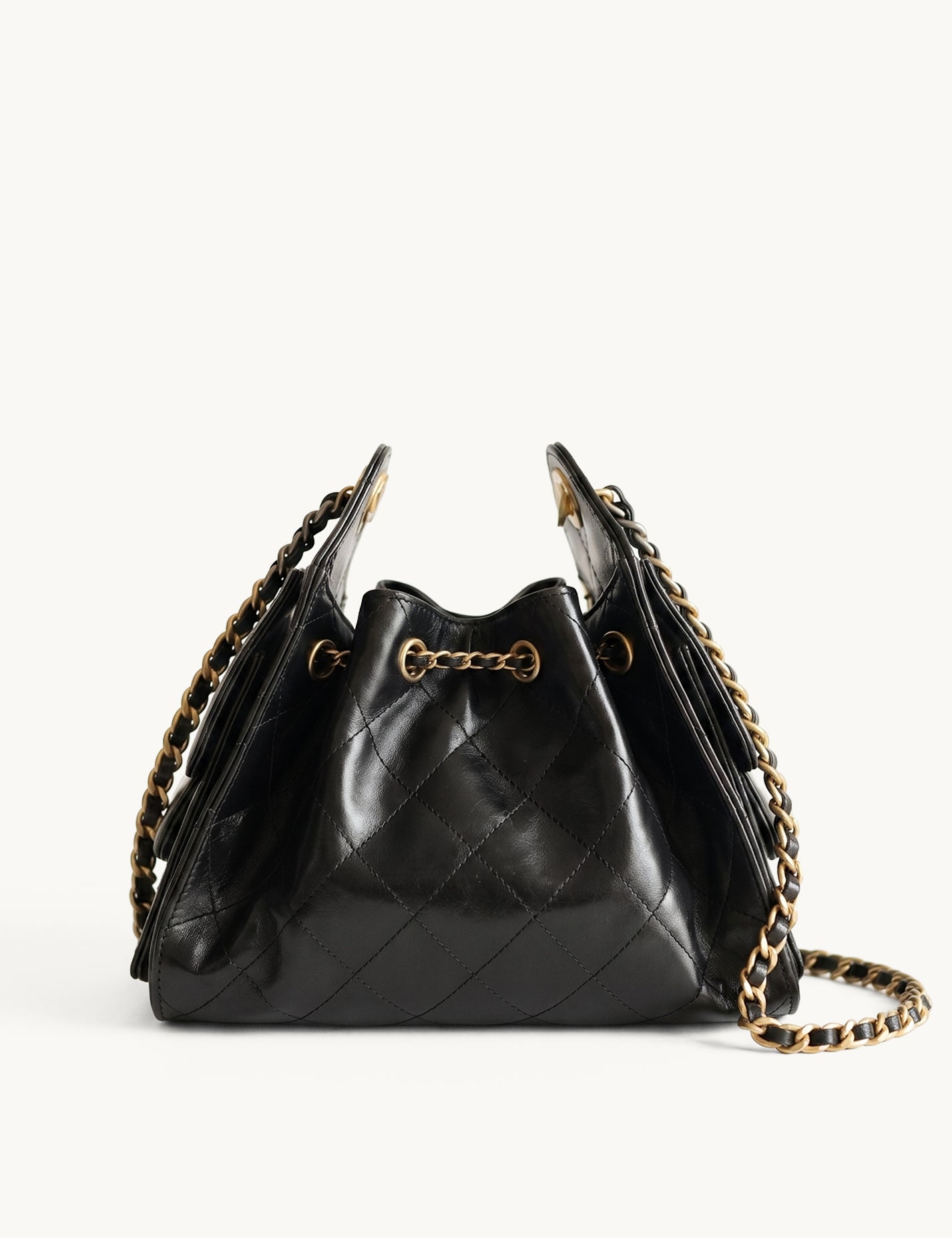 Diamant black quilted leather drawstring bucket bag with antique gold chain straps – front view