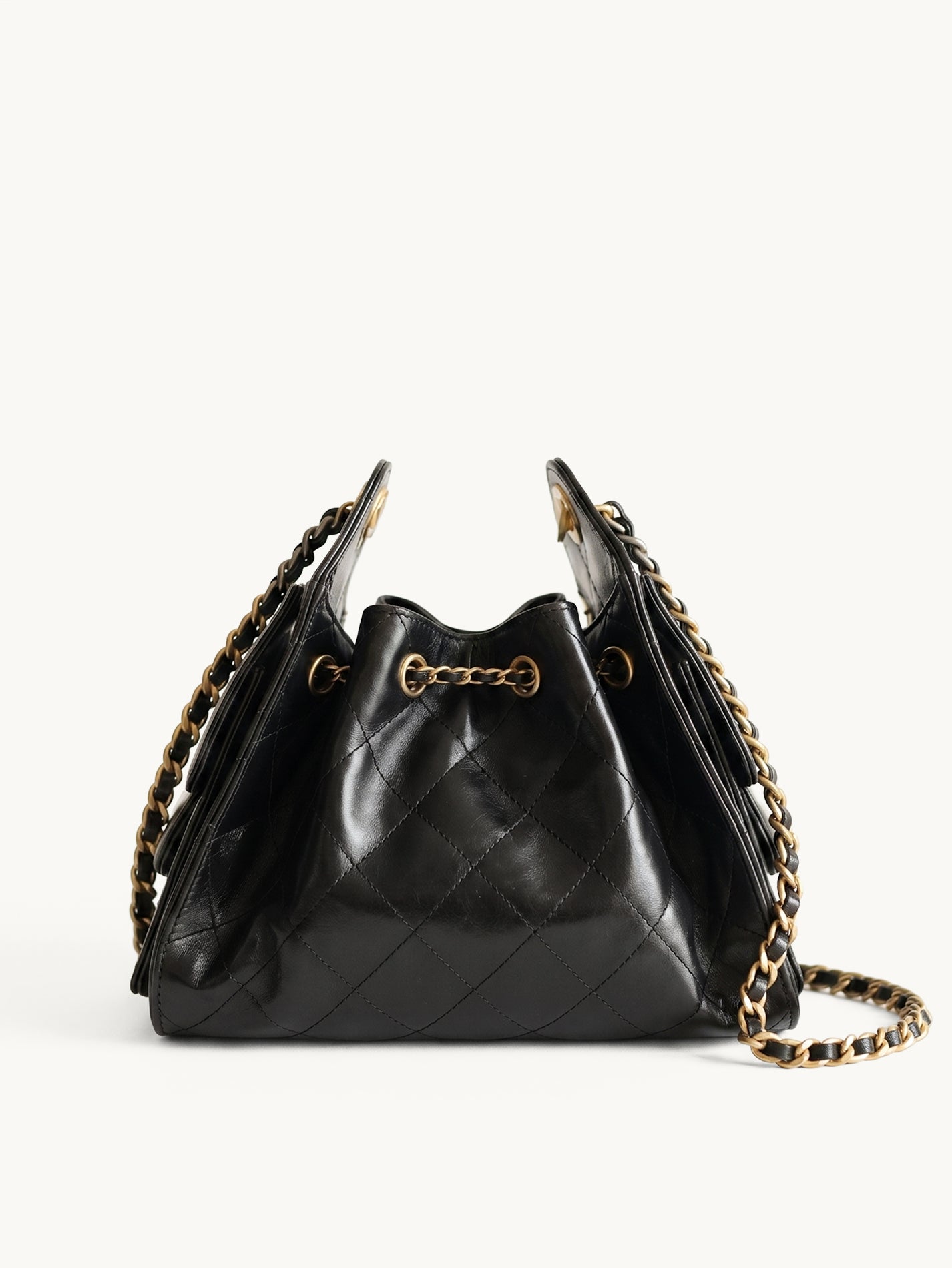 Diamant black quilted leather drawstring bucket bag with antique gold chain straps – front view