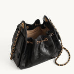 Diamant black quilted leather drawstring bucket bag with antique gold chain straps – open top view