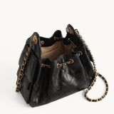 Diamant black quilted leather drawstring bucket bag with antique gold chain straps – open top view