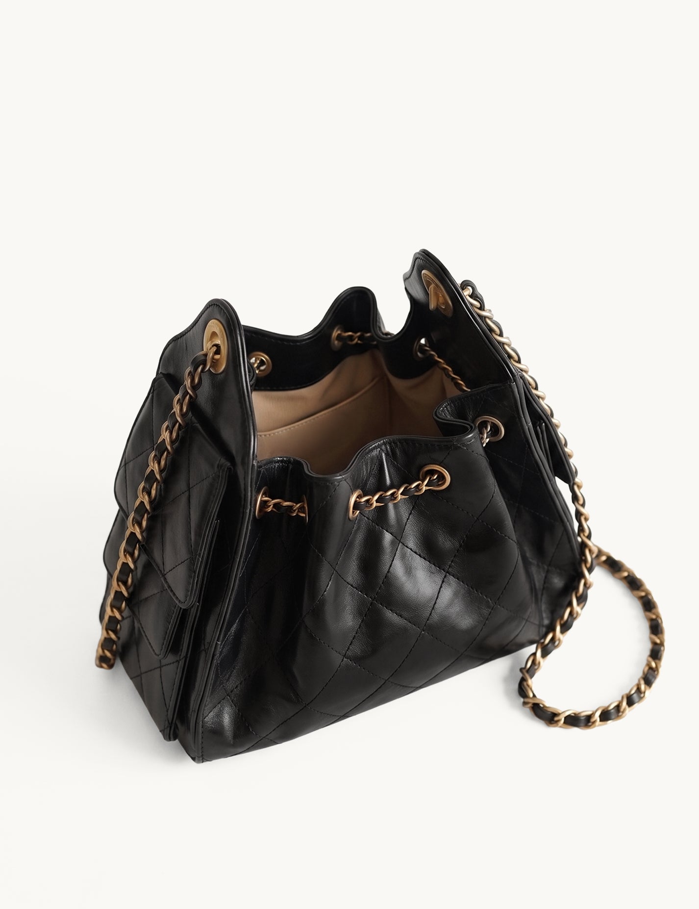 Diamant black quilted leather drawstring bucket bag with antique gold chain straps – open top view