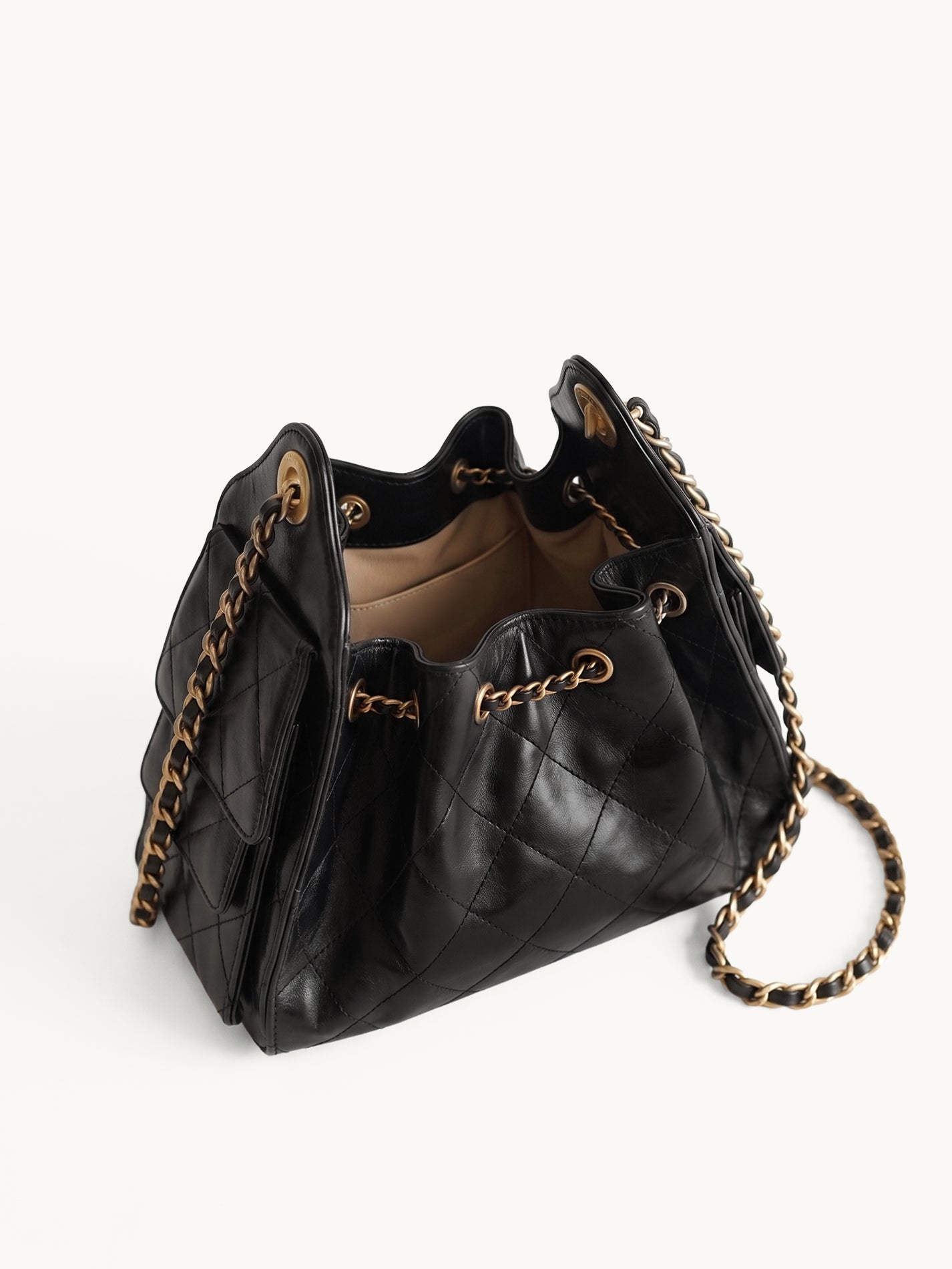 Diamant black quilted leather drawstring bucket bag with antique gold chain straps – open top view
