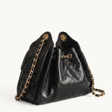 Diamant black quilted leather drawstring bucket bag with antique gold chain straps – side view